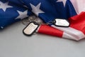 American flag and soldiers tags on background. Veterans Day Concept. Royalty Free Stock Photo