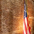 American Flag on Stand, against old brick wall Royalty Free Stock Photo