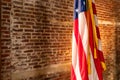 American Flag on Stand, against old brick wall