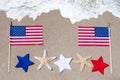 American flag with starfishes on the sandy beach