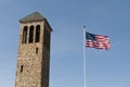 American flag and tower in the sky. Royalty Free Stock Photo