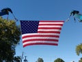 American Flag Between Two Boom Crane Hooks
