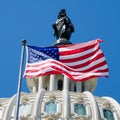 The American Flag waves in fron of the Capitol building in Washi Royalty Free Stock Photo