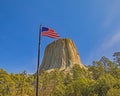 American flag waves over the Devils Tower National Monument Royalty Free Stock Photo