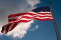 The American flag is waving against the sky. Happy 4th of July USA Independence Day. Royalty Free Stock Photo