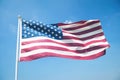 American Flag Waving in Bright Blue Sky