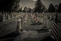 American flag waving next to a grave at the American Cemetery and Memorial. Neural network AI generated Royalty Free Stock Photo