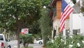 American flag waving, suburban house facade residential district, California USA Royalty Free Stock Photo
