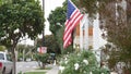 American flag waving, suburban house facade residential district, California USA Royalty Free Stock Photo