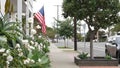 American flag waving, suburban house facade residential district, California USA Royalty Free Stock Photo