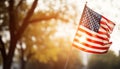 American flag waving in the sunset, symbolizing freedom and patriotism generated by AI Royalty Free Stock Photo