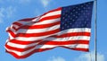 American Flag Waving Under A Blue Sky With Clouds Royalty Free Stock Photo