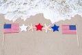 American flags with starfishes on the sandy beach