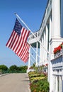 American Flags Waving in Air from White Pillar Building Royalty Free Stock Photo