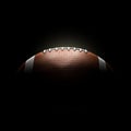 American football ball on black background