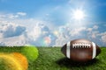 American football ball on green grass field on background of blue sky. Banner. Royalty Free Stock Photo