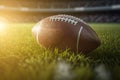 American football ball on green grass field sunset light background. Generative AI Royalty Free Stock Photo