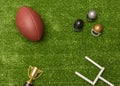 American football ball, little football helmets, goal post and golden trophy Royalty Free Stock Photo