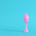 American football ball throphy on bright blue background in pastel colors. Minimalism concept