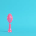 American football ball throphy on bright blue background in pastel colors. Minimalism concept
