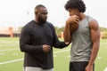 American Football coach training a young athlete.