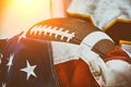 American football concept. The ball for American football lies on the flag of America against the backdrop of an