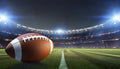 American football field with closeup on ball and stadium lights Royalty Free Stock Photo