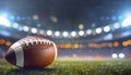 American football field with closeup on ball and stadium lights Royalty Free Stock Photo