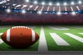 American football on field with dramatic spot lights on ball Royalty Free Stock Photo