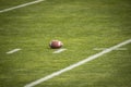 American Football field. Grass field with a football resting on the yard marker. Royalty Free Stock Photo