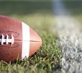 American Football on the field with green grass Royalty Free Stock Photo