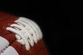 American Football Game Ball Laces and Texture Detail Against a Black Background Royalty Free Stock Photo