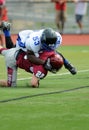 American football game - hard tackle Royalty Free Stock Photo