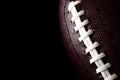 American football and gameday poster concept with close up on the texture of a ball with dramatic moody light with high contrast