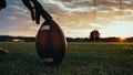American Football Kickoff Game Start. Close-up Shot of an American Ball Standing on a Grass Field