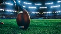 American Football Kickoff Game Start. Close-up Shot of an American Ball Standing on a Stadium Field