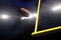 American football over goal post at night