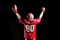 American football player cheering with arms up