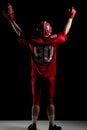 American football player cheering with arms up