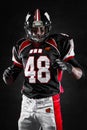 American football player on dark background Royalty Free Stock Photo