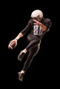 American football player in a jump with a ball on a black background Royalty Free Stock Photo