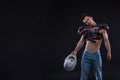 American football player with helmet in hand on black background Royalty Free Stock Photo