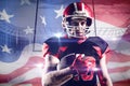 Composite image of american football player in helmet holding rugby ball Royalty Free Stock Photo