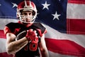 Composite image of american football player in helmet holding rugby ball Royalty Free Stock Photo