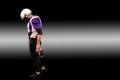 American football player holding ball in his hands in smoke. Black background, copy space. The concept of American Royalty Free Stock Photo