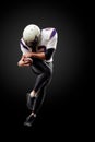 American football player in a jump with a ball on a black background Royalty Free Stock Photo