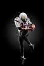 American football player in a jump with a ball on a black background Royalty Free Stock Photo