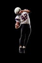 American football player in a jump with a ball on a black background Royalty Free Stock Photo