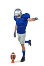 American football player kicking ball