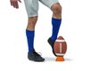 American football player kicking ball